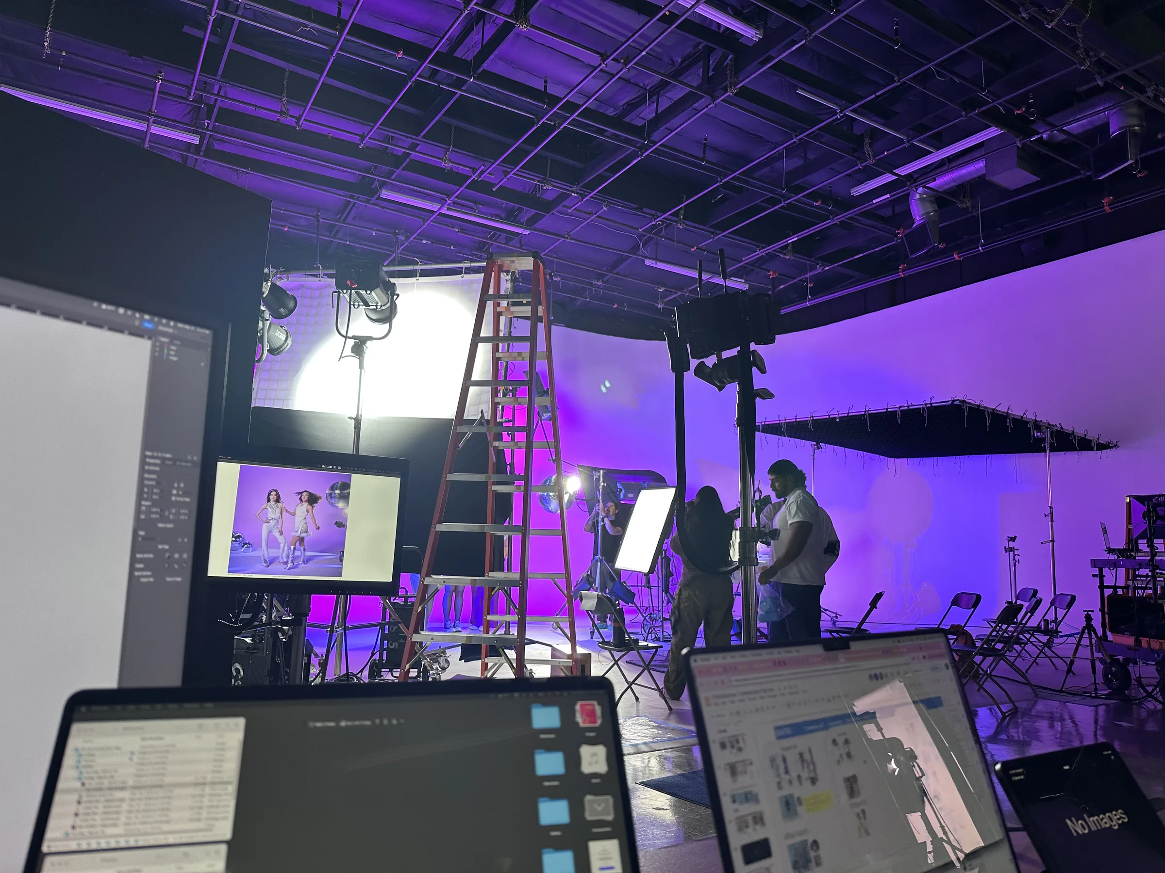 Purple and magenta set from workstation — Pop Culture section being shot with monitors and control station visible