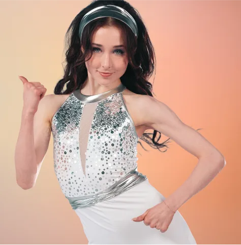 Groovy category tile — dancer in white sequined top with black wide-leg pants