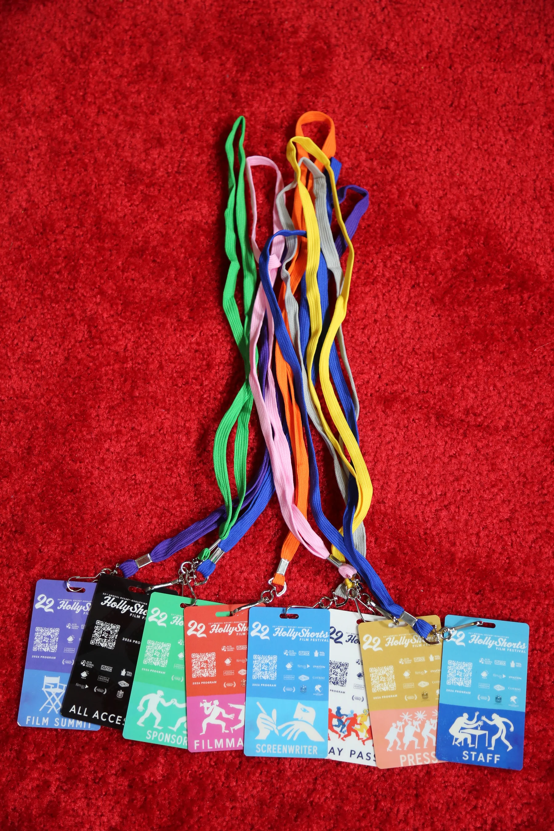 The eight badges on their lanyards, on the red carpet