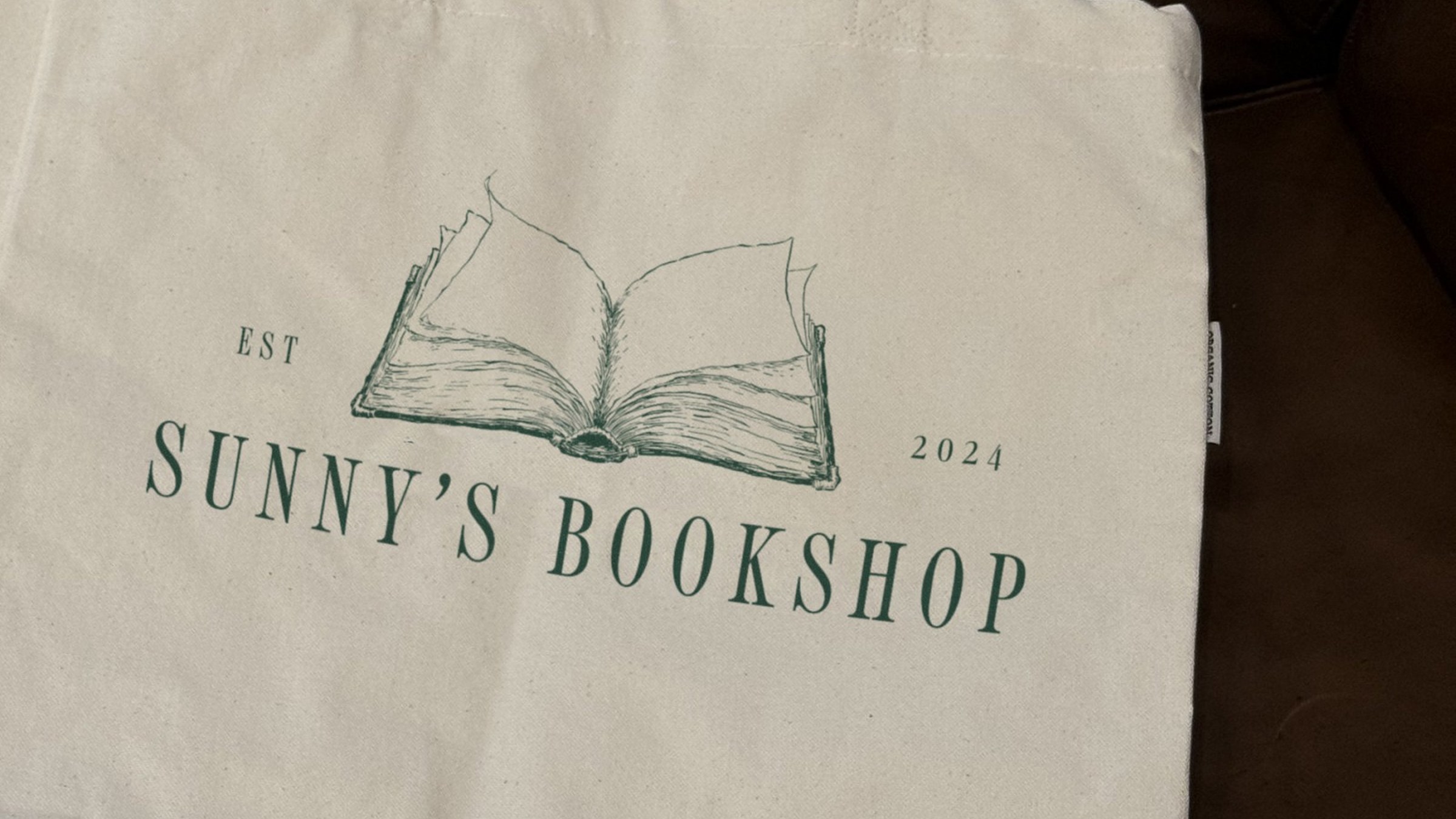 A canvas tote printed with the horizontal logo.