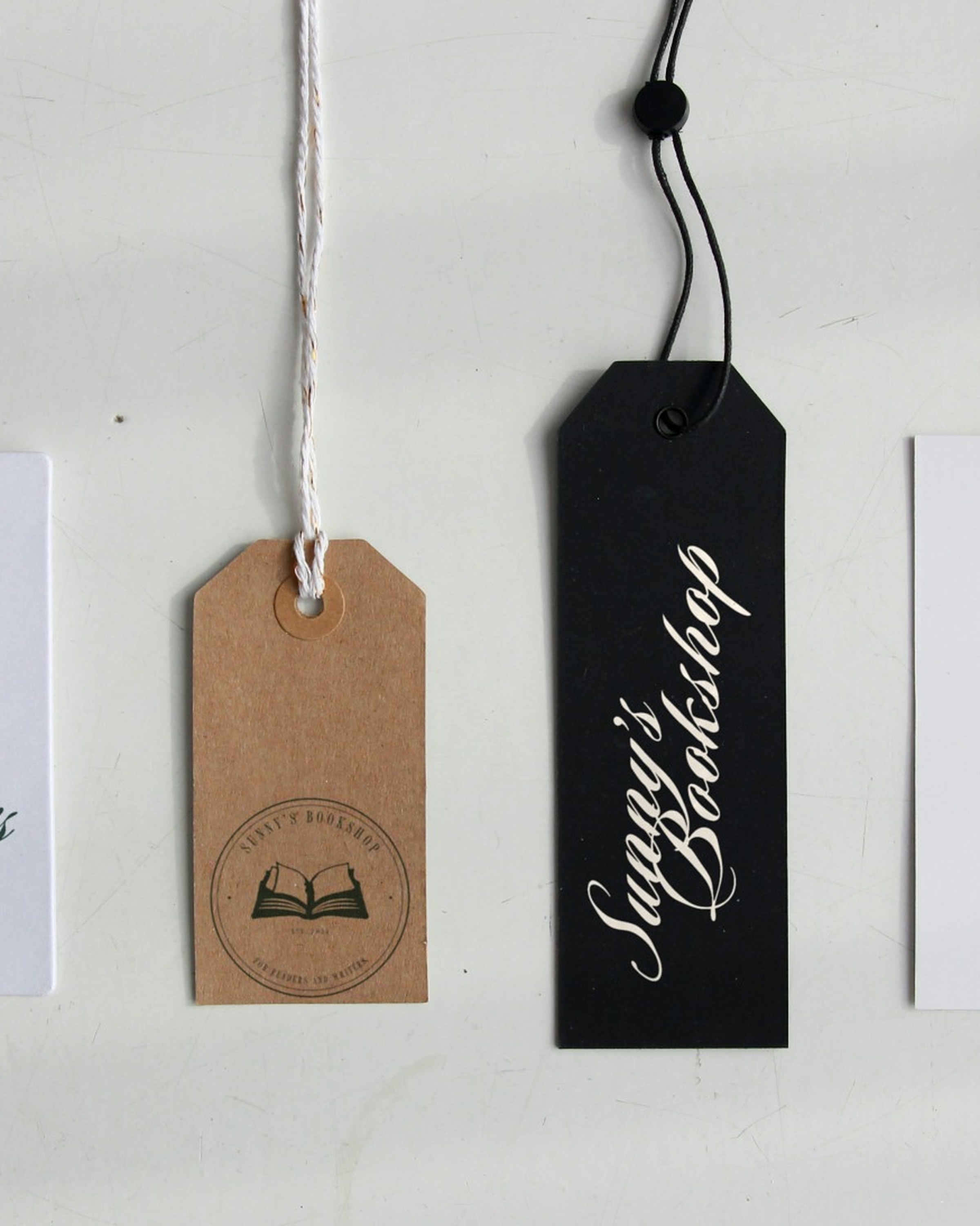 Hang tags: the seal stamped on kraft, the signature on black.