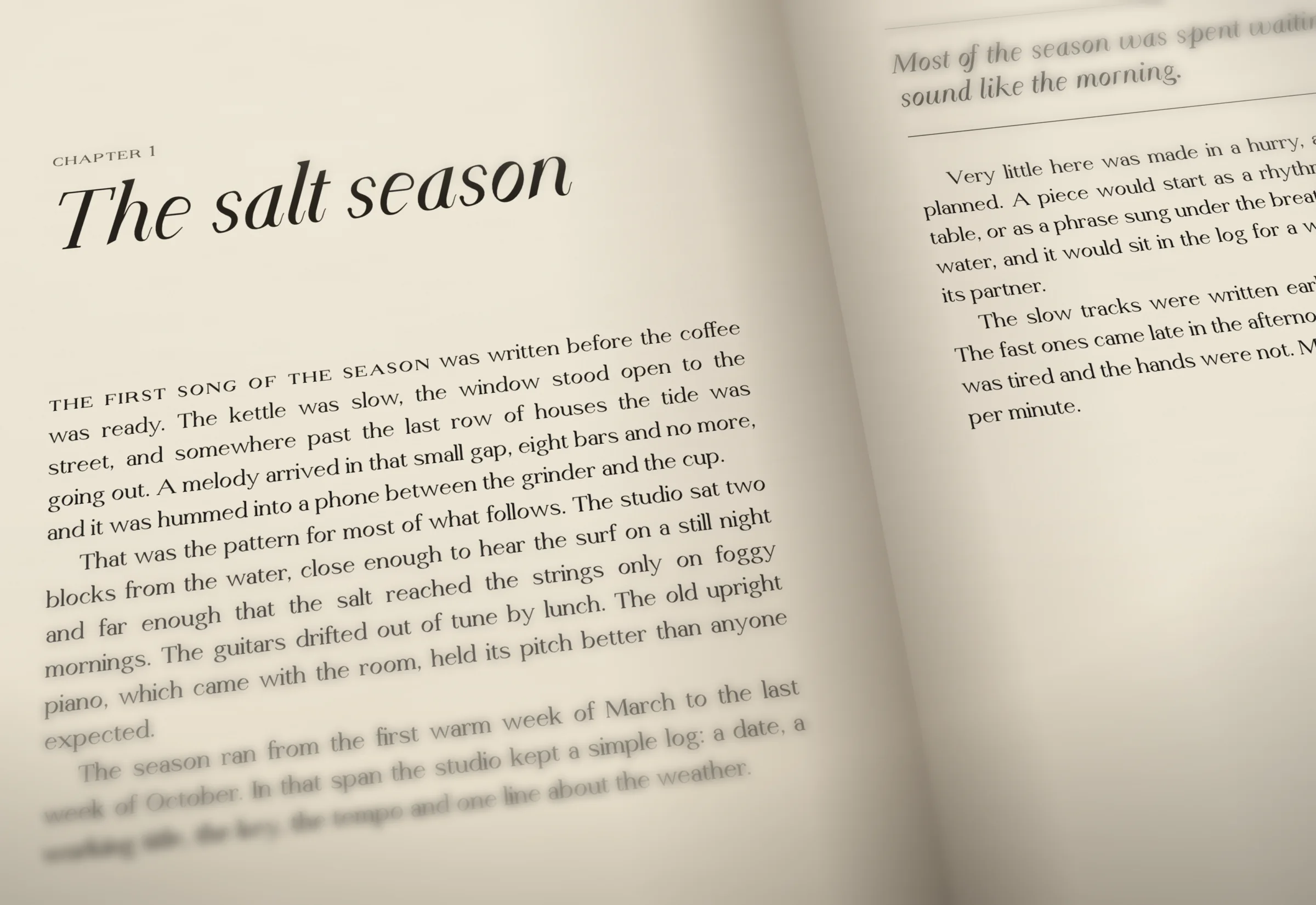 A book open on a desk, close: a chapter opening set in Opmet Serif, the title in Display Italic and the text in Text Regular, with small caps and oldstyle figures.